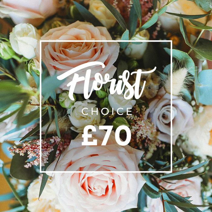 A vibrant, inviting overhead view of a premium Florist Choice bouquet, arranged to read as both an intimate still life and a clear product image. Prominent are several large, full-headed roses in soft blush pink, creamy ivory and warm peach, their petals unfolding with a gentle, sculptural grace. Cooler notes come from muted lavender and dusty mauve roses tucked between the main blooms, providing subtle depth. Fine sprays of white filler flowers-likely waxflower or small gypsophila-form a delicate lacework, while tiny pink berry clusters add rhythm and a hint of playfulness. Natural, dried accents in cream and tan-feathery grasses and textured seed pods-bring an organic, slightly rustic lift that contrasts the lushness of the fresh blooms. Rounded eucalyptus leaves in a dusty blue-green weave throughout, offering a cool, aromatic contrast and visual breathing space. Superimposed centrally is a neat white square outline containing the promotional copy: the script Florist Choice, a smaller uppercase CHOICE beneath it, and the bold price ?70 at the bottom, all in white to sit harmoniously over the floral tones. The soft, diffuse lighting and selective focus emphasize petal texture and scent-memory: imagine a gentle rose perfume threaded with eucalyptus freshness. This image reads as a signature offering from a local artisan florist-perfect for customers browsing bespoke bouquet options or searching for a refined delivery to addresses around Tolworth, Kingston and nearby neighbourhoods.